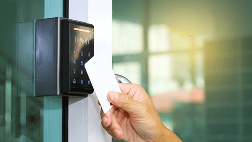 Modern access control keypad and card reader system installed on commercial building entrance